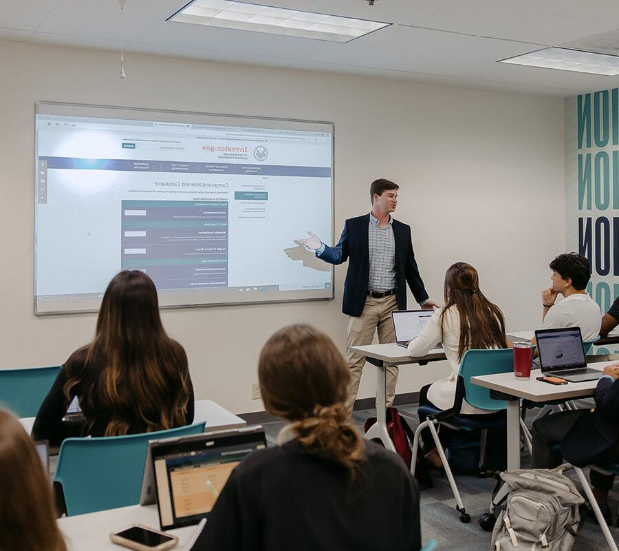 Students listen to an organizational leadership lecture.